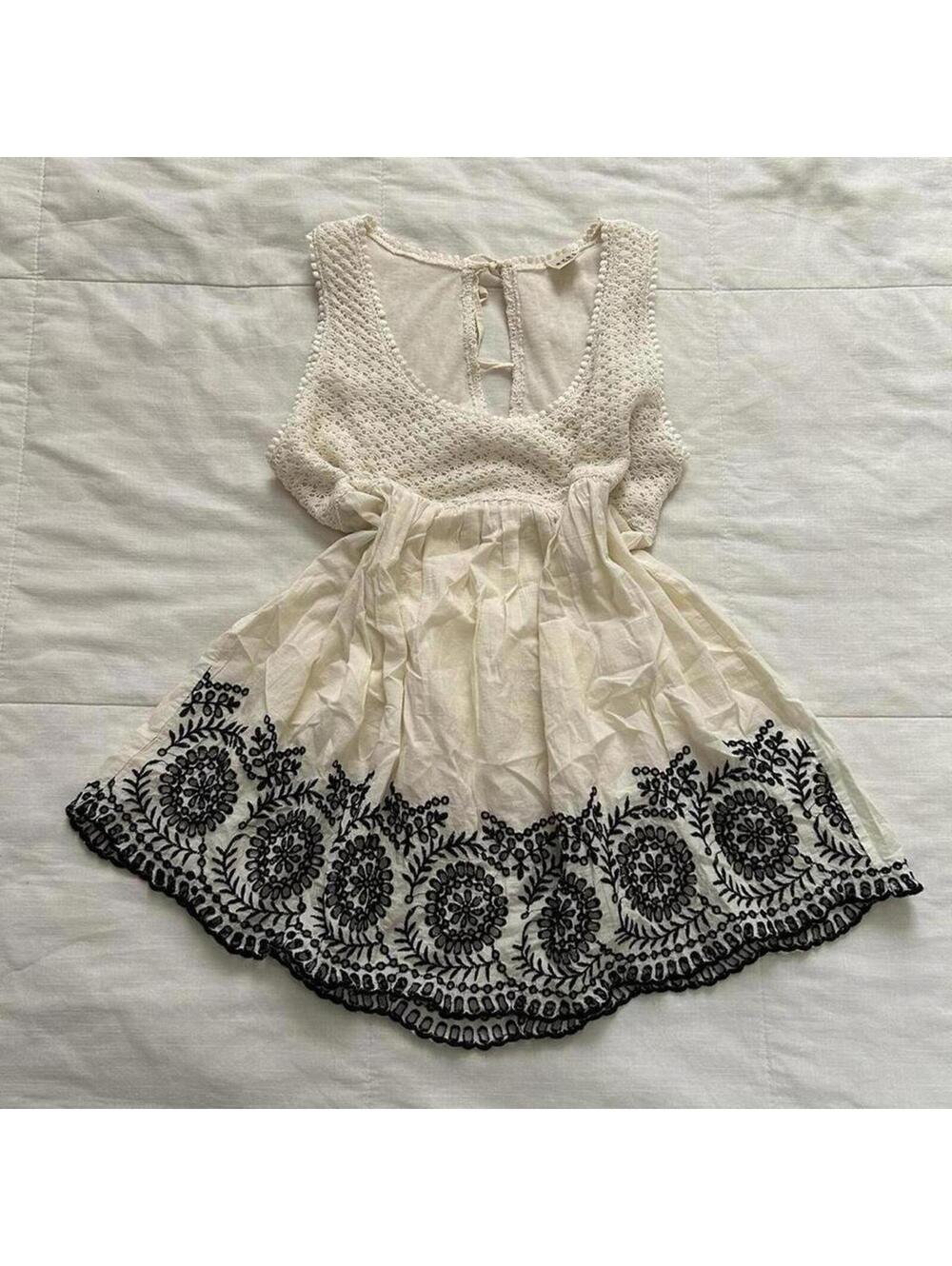Axes Femme cream sleeveless top with black lace trim and tie back detail